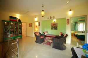 a living room with chairs and a table in it at Bella Homestay Kerala in Alleppey