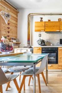 a kitchen with a glass table and chairs at Il Baitino Innamorato in Pragelato