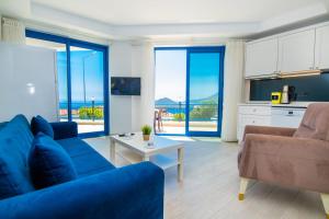 a living room with a blue couch and a table at Carpediem Apart in Kaş