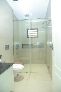 a bathroom with a glass shower and a toilet at Wariyam Heritage in Trichūr +21 photos