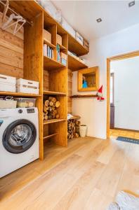 a washer and dryer in a room with wooden walls at Il Baitino Innamorato in Pragelato