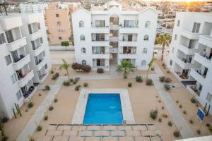 an aerial view of an apartment complex with a swimming pool at Downtown Beach Condo w/ Pool in Cabo San Lucas