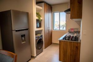 a kitchen with a stainless steel refrigerator and a dishwasher at Downtown Beach Condo w/ Pool in Cabo San Lucas