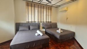a bedroom with two beds and a window at Luxpro Luxury Villa / Seremban 2 / Private Swimming Pool in Seremban +49 photos