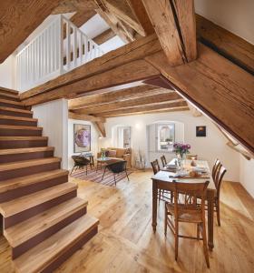 a living room with a staircase and a table and chairs at Engelwirt Apartments in Berching