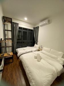 a bedroom with two large beds and a window at K avenue Studio 2bed room A06 near airport by GC in Donggongon