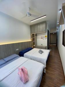 a room with two beds with towels on them at K avenue Studio 2bed room A06 near airport by GC in Donggongon