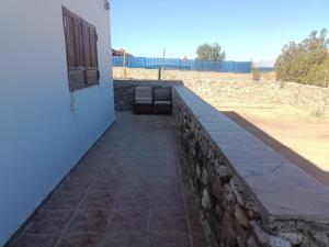 a retaining wall with a bench next to a building at An na no in Nuweiba