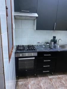 a kitchen with a stove and a sink at MozBnb in Maputo