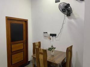 comedor con mesa y ventilador en la pared en Malki Villa, en Weligama