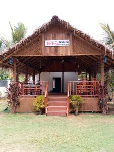 a building with a restaurant with a sign on it at JEYs Place in Nilaveli