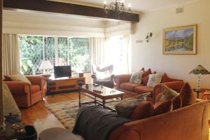 a living room with couches and a table at Umoya in Hilton