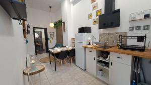 a kitchen with a counter and a table with chairs at URBAN LOFT VALENCIA in Valencia