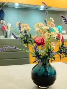 a blue vase filled with flowers on a table at Nido al Mare in Bonassola