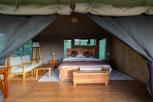 a bedroom with a bed in a tent at Serengeti Kifaru Tented Lodge in Mugumu