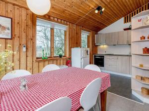 a kitchen with a red and white table and chairs at Holiday home Bedsted Thy III in Bedsted Thy
