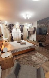 a large bedroom with a bed and a couch at Cuza 21 in Brăila