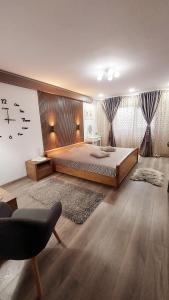 a bedroom with a bed and a clock on the wall at Cuza 21 in Brăila