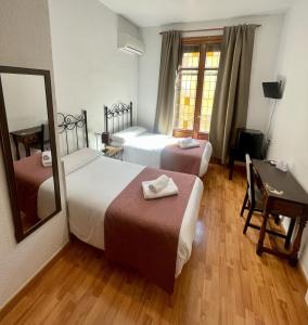 Postel nebo postele na pokoji v ubytování Arteaga Hostal & Baños Arabes Elvira