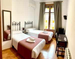 Postel nebo postele na pokoji v ubytování Arteaga Hostal & Baños Arabes Elvira