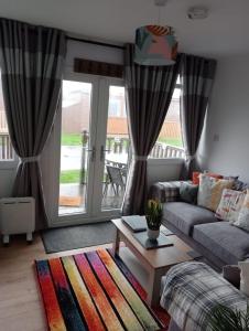 a living room with a couch and a table at J16 Mablethorpe Pet Friendly Chalet in Mablethorpe