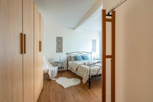 a bedroom with a bed and a door leading into a room at Duomo & Station - Self check-in & access in Como