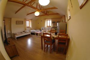 a kitchen and living room with a table and chairs at Penzion Hradební in Telč