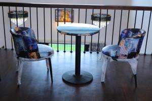 two chairs and a table in a room at Castle WinterFell (SVT) in Kodaikānāl +14 photos