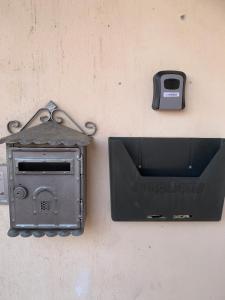 a toaster sitting on the side of a wall at Appartamento al Lago in Castiglione del Lago
