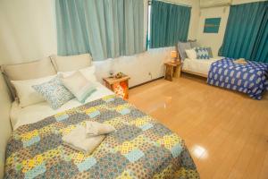 a bedroom with a bed and a couch in it at 最大11名宿泊可！憧れのプール付き一軒家をあなただけの貸切に。～ここから始まる贅沢な南国ライフを～ in Yabu