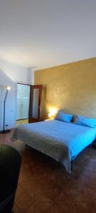 a bedroom with a large bed with blue sheets at Casa Robert in Alessandria