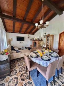 a living room with a table with chairs and a couch at Vila La Perla Istriana in Višnjan