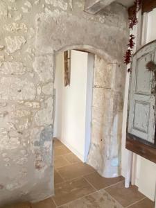 a hallway in a castle with a stone wall at Les Chantours in Saint-Antoine-Cumond
