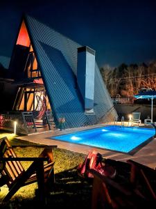 a swimming pool in front of a building at night at World DREAMS Forest in Sapanca