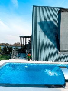 a large blue swimming pool next to a building at World DREAMS Forest in Sapanca