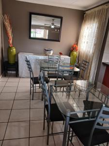 a dining room with a table and chairs at Tushiya guest lodge witbank in eMalahleni