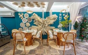 a dining room with a table and chairs and a christmas tree at The Color Kata in Kata Beach