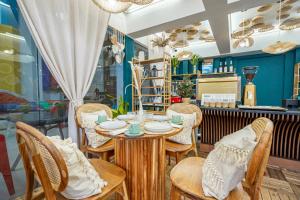 a dining room with a table and chairs at The Color Kata in Kata Beach