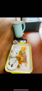 a tray with a plate and a cup on a table at KHÁCH SẠN HOÀNG TRIỀU in Chánh Long