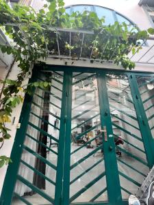 a green door with plants on top of it at Private Homestay District 1, Tan Ðinh Ward, HCM City in Ho Chi Minh City