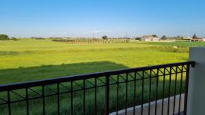 a balcony with a view of a green field at Eleonas Garden Apartments in Sotira
