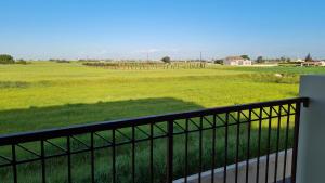 a balcony with a view of a green field at The Olive Grove Escape, Eleonas Apts in Sotira