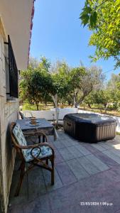 a patio with a table and a large tire at Villa Kavalino in Kolimbia