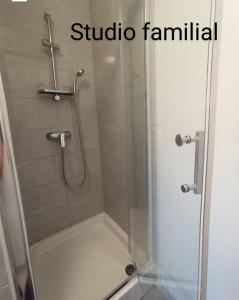 a shower with a glass door with the words studio family at Studio Quiétude in Saint-Aygulf