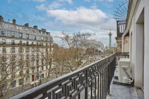 a balcony with a view of a city with buildings at Apartment Le Marais by Studio prestige in Paris