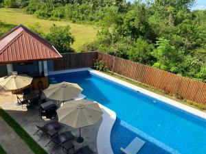 an overhead view of a swimming pool with umbrellas at Malipaj Apartments in Panglao Island