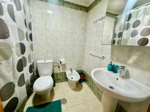 a bathroom with a toilet and a sink at La Loma 72 in Torrevieja +13 photos