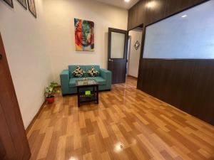 een woonkamer met een bank en een projectiescherm bij Sixth Sense Lokhandwala in Mumbai