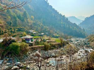 a view of a valley with a river and mountains at Sainj Riverside Cottages in Sainj