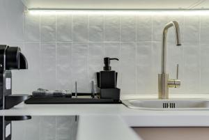 a kitchen counter top with a sink and a sink at Hann Haven Apartments Armii krajowej 16 in Opole